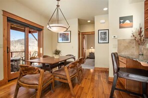 Enjoy meals in this dining area with a table, chairs, and a large window offering a view.