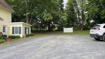 A residential driveway leading to a house with a small attached garage.