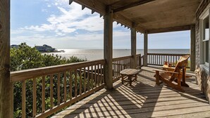 A wooden deck with a view of the ocean, wooden chairs, and a railing. - 7825-The Carolina Moon - Soundfront Frisco Home | Sunset Views (Frisco)