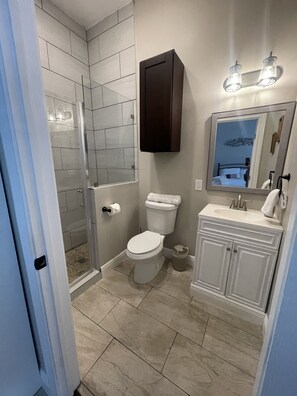 Shower, hair dryer, towels, toilet paper