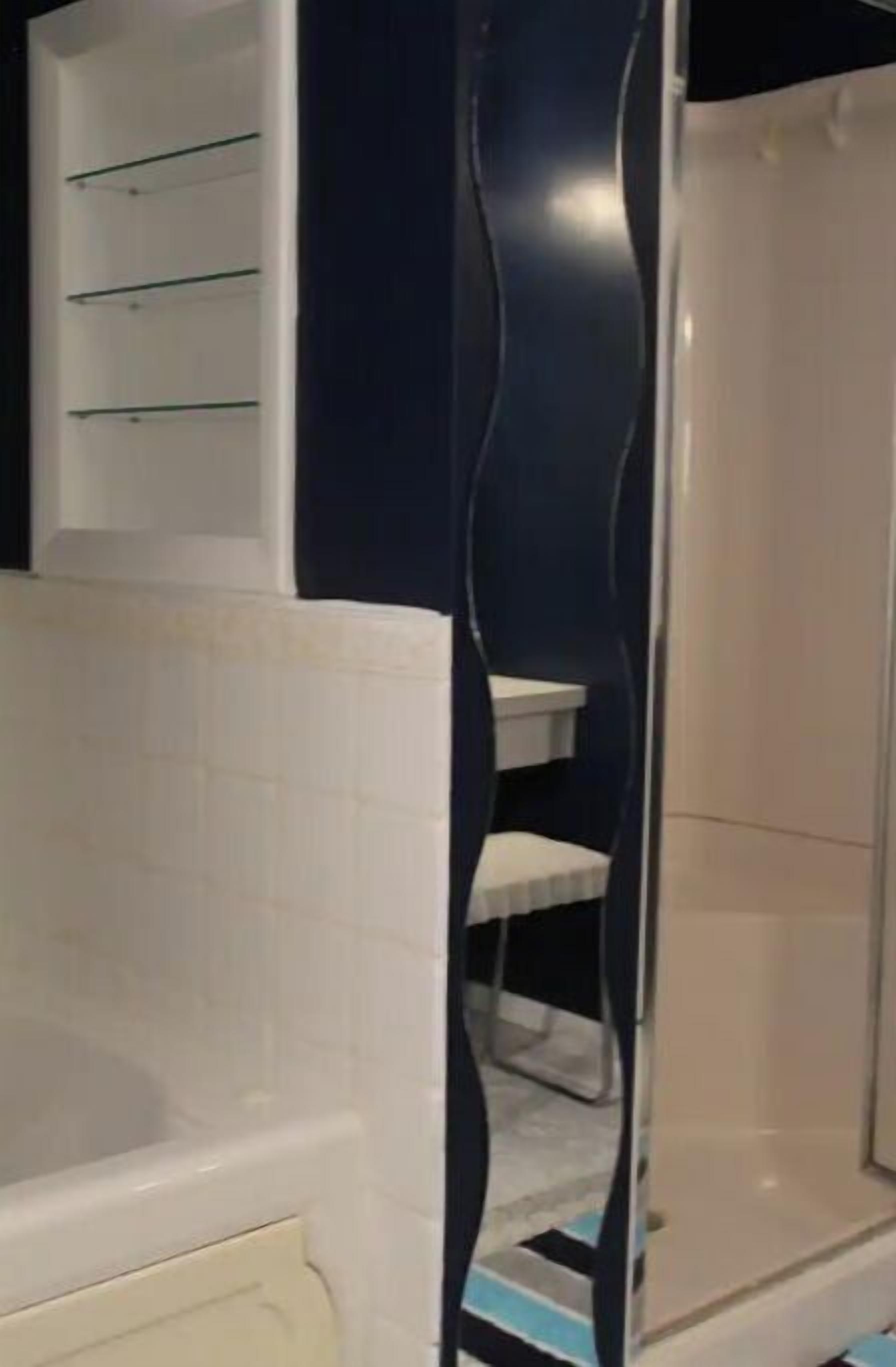 A bathroom with a white bathtub, a white sink, and a shower area.
