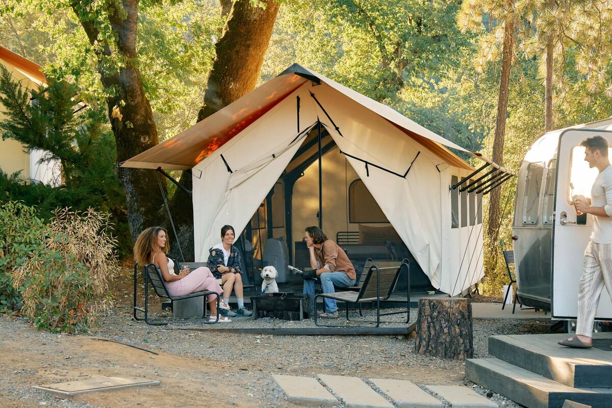 A campsite with a tent and a trailer.