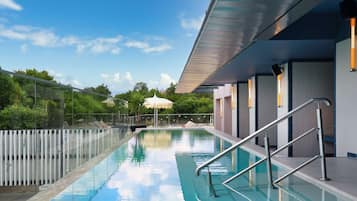 Una piscina al aire libre de temporada, sillones reclinables de piscina