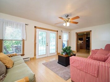 Sunlit living room with a Queen Futon and Sleeper Sofa