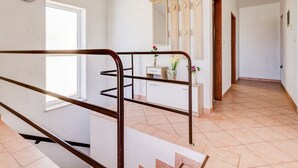 A spacious hallway with a wooden staircase, a white wall, and a tiled floor. - Balcony with sea view, FAZANA, 280m to the main beach, 400m to the old town  (Fažana)