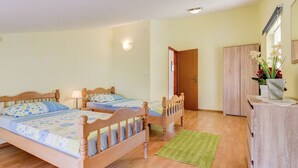 A bedroom with two wooden beds, a green rug, a wooden wardrobe, and a mirror on the wall. - Balcony with sea view, FAZANA, 280m to the main beach, 400m to the old town  (Fažana)