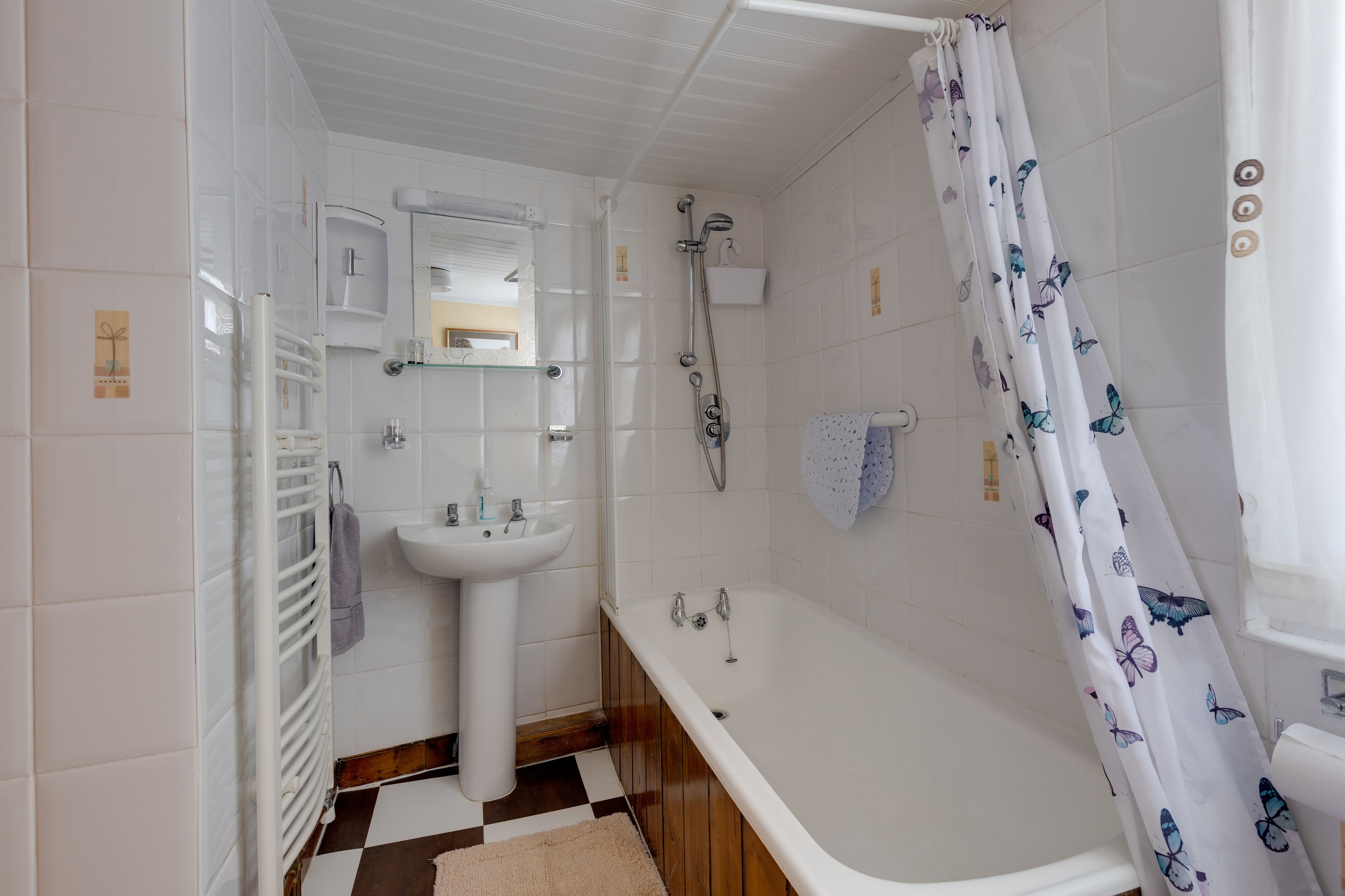 A bathroom with a bathtub, a sink, and a shower.