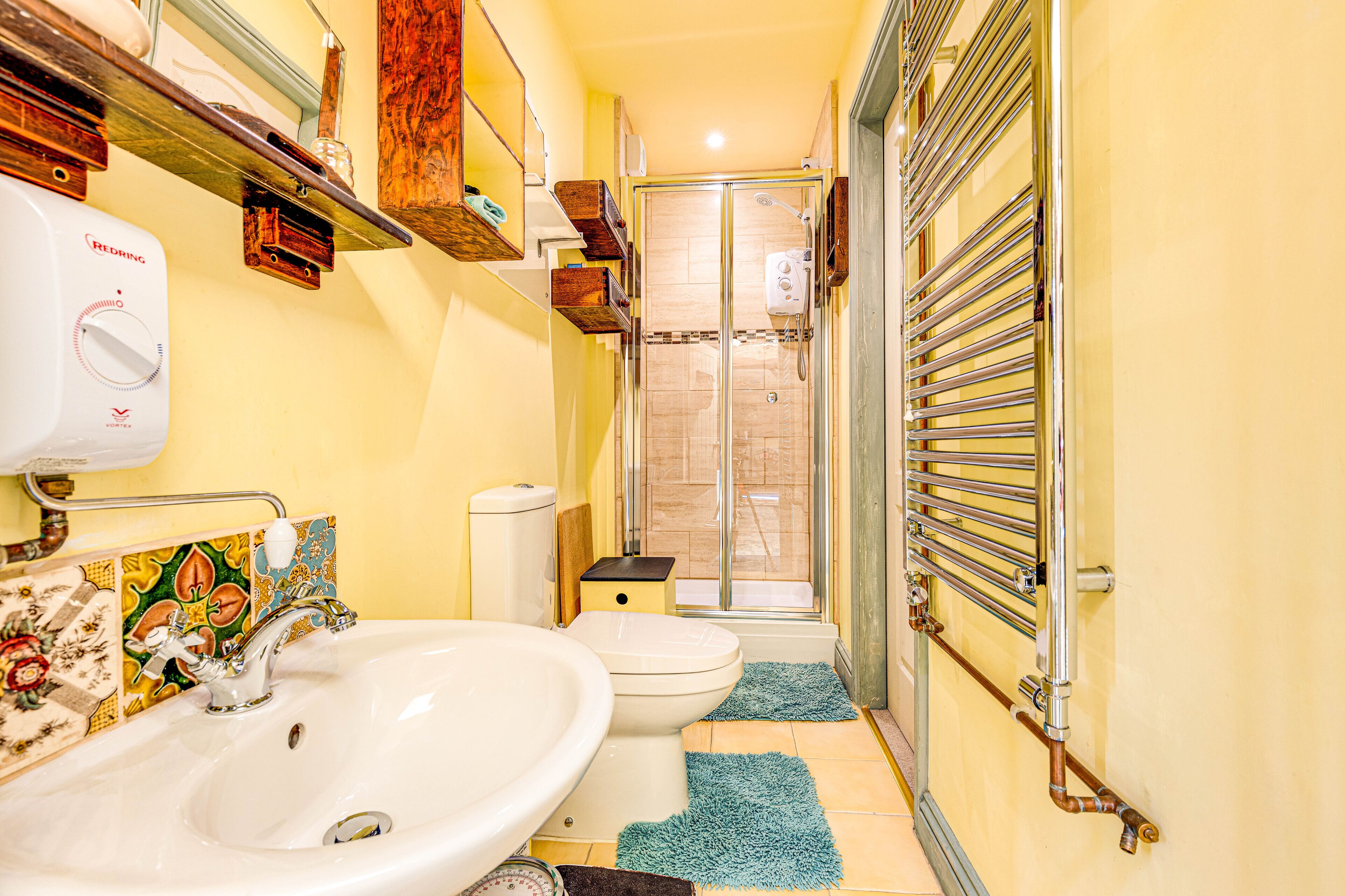 Une salle de bain avec un lavabo, des toilettes et une douche.