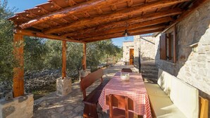 A stone building with a wooden pergola over a stone patio. - Stone House Lozica Vela Luka (Vela Luka)