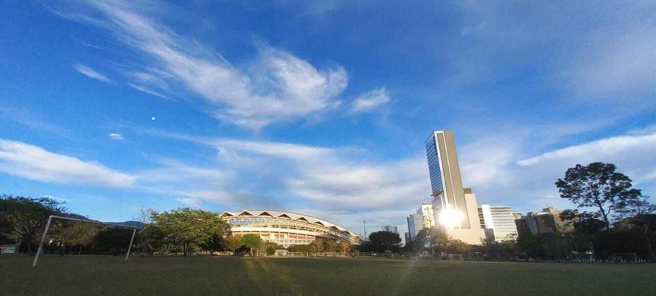 A stadium with a tall tower in the background.