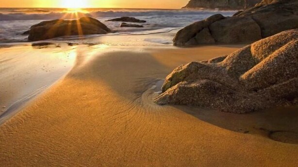 A beach scene with the sun setting over the ocean, rocks, and sand. - Spacious Pacifica Beach Home  Sleeps 14 Game Room (Pacifica)