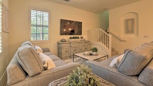 A living room with a grey sofa set, a coffee table, and a ceiling fan. - Ole at Lely Resort Condo w/ Pool Access! (Naples)