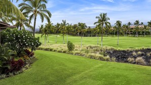 A well-maintained golf course with lush green grass, palm trees, and a clear sky. - Colony Villas Waikoloa 301 2 Bedroom Villa by RedAwning (Waikoloa)