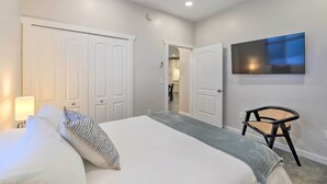 A hotel room with a bed, a TV mounted on the wall, and a chair. - Cozy Home: Mtn Views, A/C, in Heart of Star Valley (Etna)