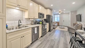A modern kitchen with white cabinetry, stainless steel appliances, and a granite countertop. - Cozy Home: Mtn Views, A/C, in Heart of Star Valley (Etna)
