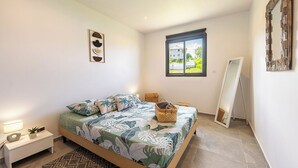 A bedroom with a bed, a nightstand, a window, and a mirror. - Romantic Villa Laupie 5 minutes from Case Pilote, a haven of peace (CASE PILOTE)