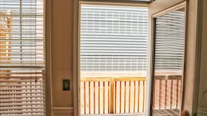 A room with a wooden deck visible through a window with blinds. - Ravishing Downtown Home (Atlanta)