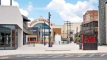 Regal Cinema with a modern facade, a fountain, and an Atlantic Station sign.