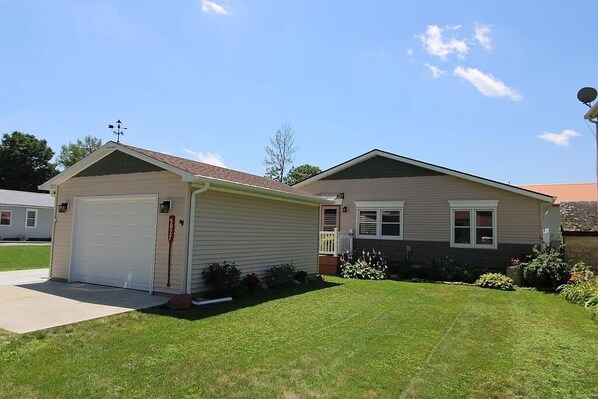 A two-story house with a garage and a small porch.