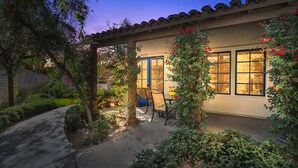 A house with a covered patio, a door, and windows. - Single story Luxurious 1 BR 1 BA Kitchen Living Resort Pools Gym (La Quinta)
