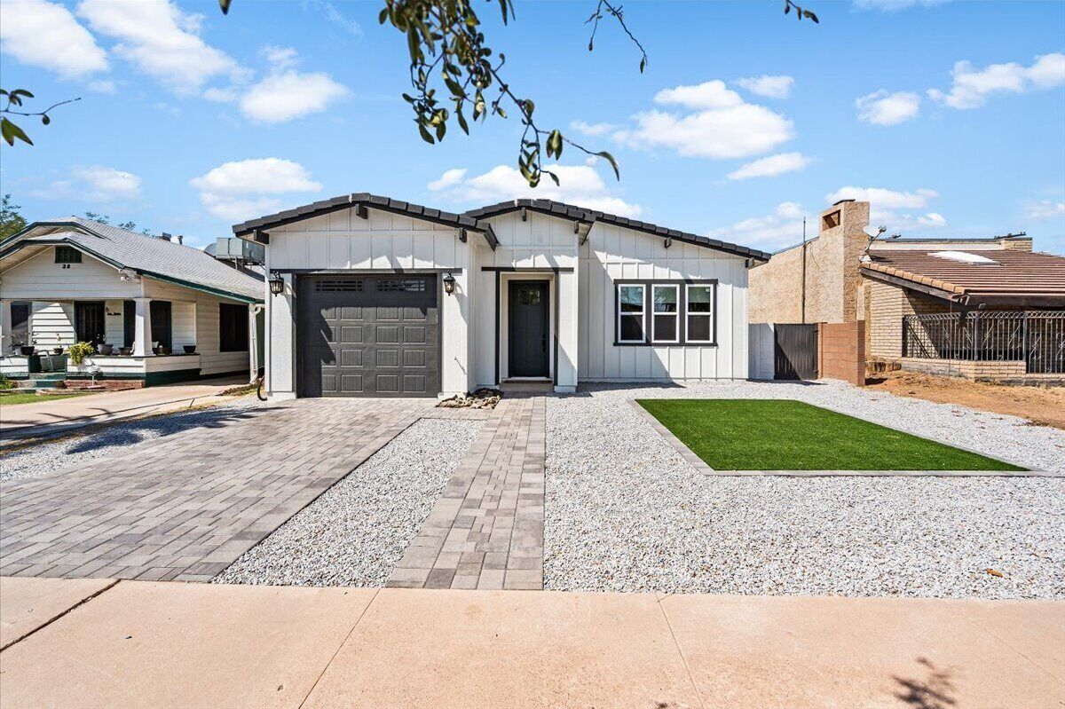 A single-story house with a garage, a front lawn, and a driveway.