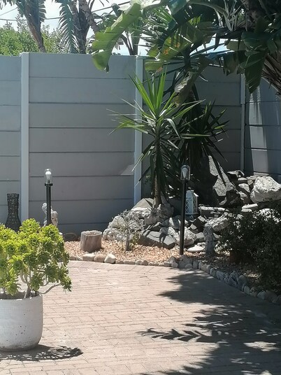 Cozy cottage for family getaway with private patio and pool in safe suburb.