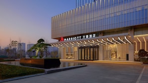 A modern Marriott hotel with a glass facade, a landscaped entrance, and a well-lit outdoor area. - Changzhou Marriott Hotel Jintan (Changzhou)