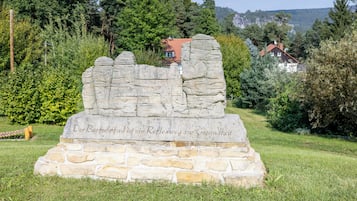 A stone monument with inscriptions in a natural setting.