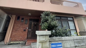 A two-story building with a flat roof and a balcony on the upper floor. - Chatan Beach House 1 (Chatan)