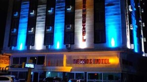 A hotel with a prominent sign reading "HOTEL" and "THE TROS HOTEL" on the facade. - Metros Hotel (Mersin)