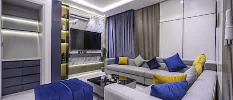 Apartment, 2 Bedrooms | Living area | 70-inch TV with digital channels