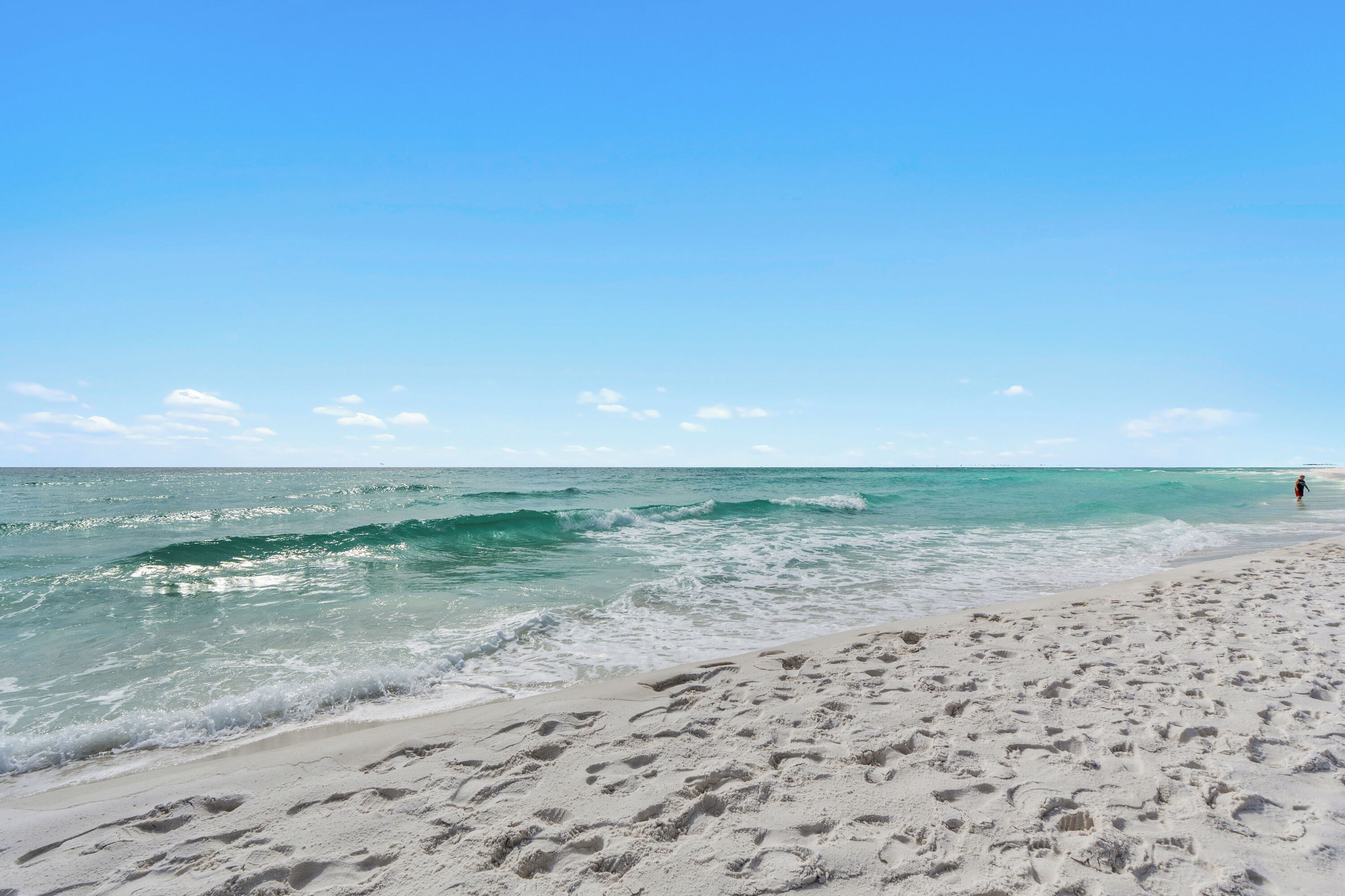 A beach with clear skies and calm waters.