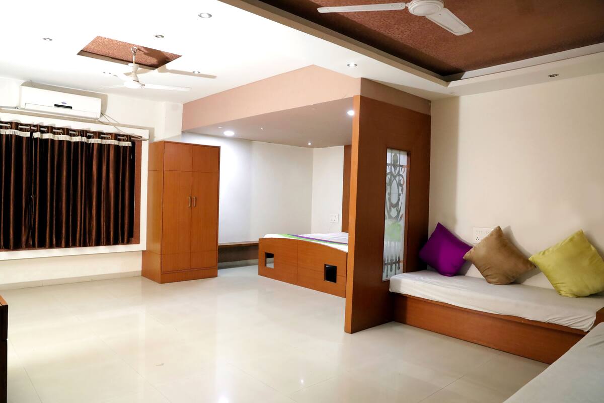A modern room with a bed, wardrobe, and built-in seating area.
