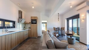 A modern kitchen with wooden cabinets, a built-in oven, and a large window. - Villa Sea-Esta in Sellia with spectacular Sea view and pool, Adults Only (Rethymno)