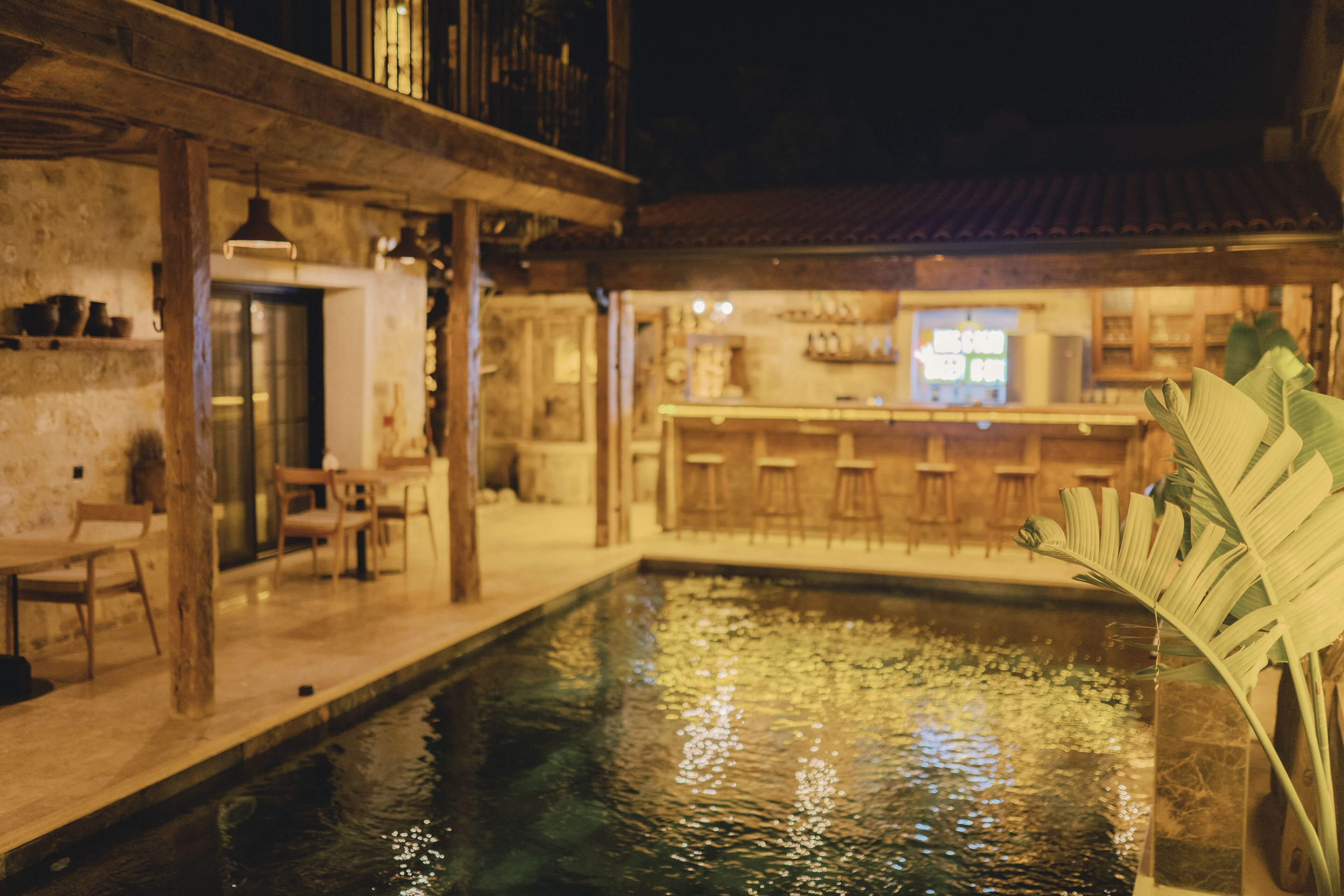A pool area with a bar and seating.