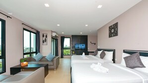 A hotel room with two beds, a sofa, a small table, and a TV. - NORN Rimklong Bangkok Hotel (Bangkok)