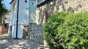 A traditional stone building with a white exterior and a small window. - Coquetdale Cottage in Rothbury, quiet village location (Rothbury)