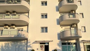 A modern multi-story building with balconies, a central entrance, and a flat facade. - Albergo 3 Torri (Maddaloni)