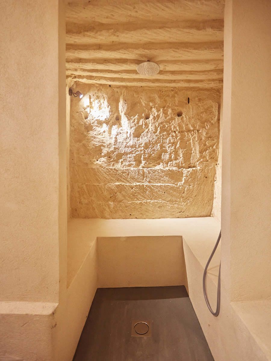 A narrow, enclosed space with a textured ceiling and a single light fixture.