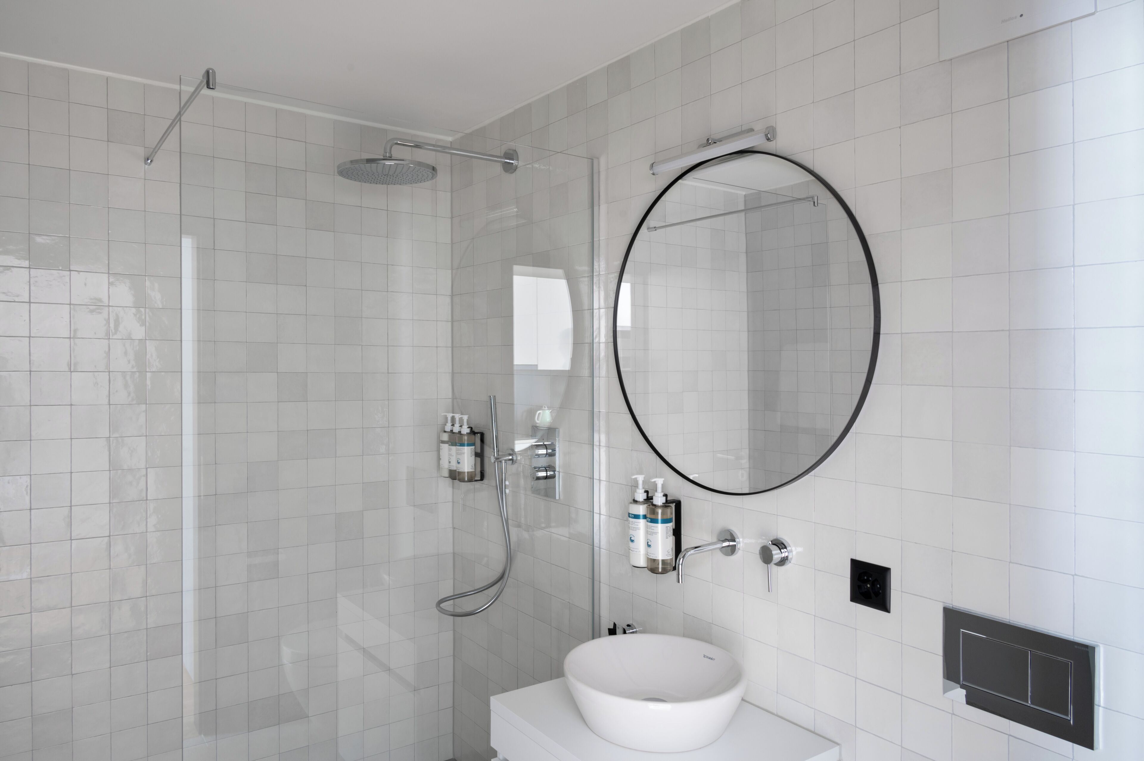 Shower, designer toiletries, hair dryer, towels