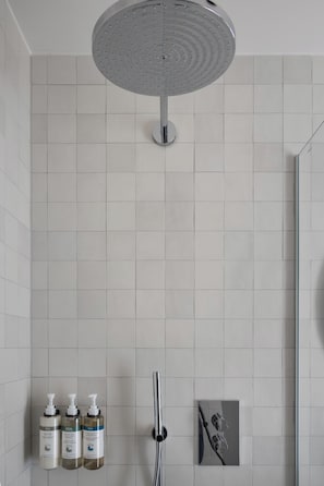 Shower, designer toiletries, hair dryer, towels