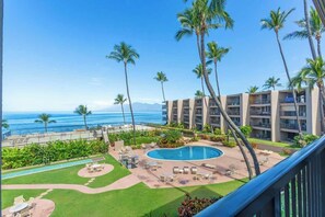 A hotel with a pool, palm trees, and a view of the ocean. - Upgraded 1 bedroom condo with stunning  oceanview throughout, walkable area (Napili-Honokowai)
