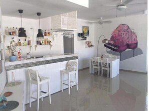 Enjoy cooking in this well-equipped kitchen with a central island, sink, and stove, and dine in the adjacent seating area.