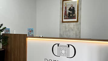 A reception desk with a sign reading "Dominium Residence".