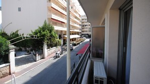 A street view with a building, a red awning, and a parked bicycle. - Palais Rouaze/ Beg4012/ 2P (Cannes)