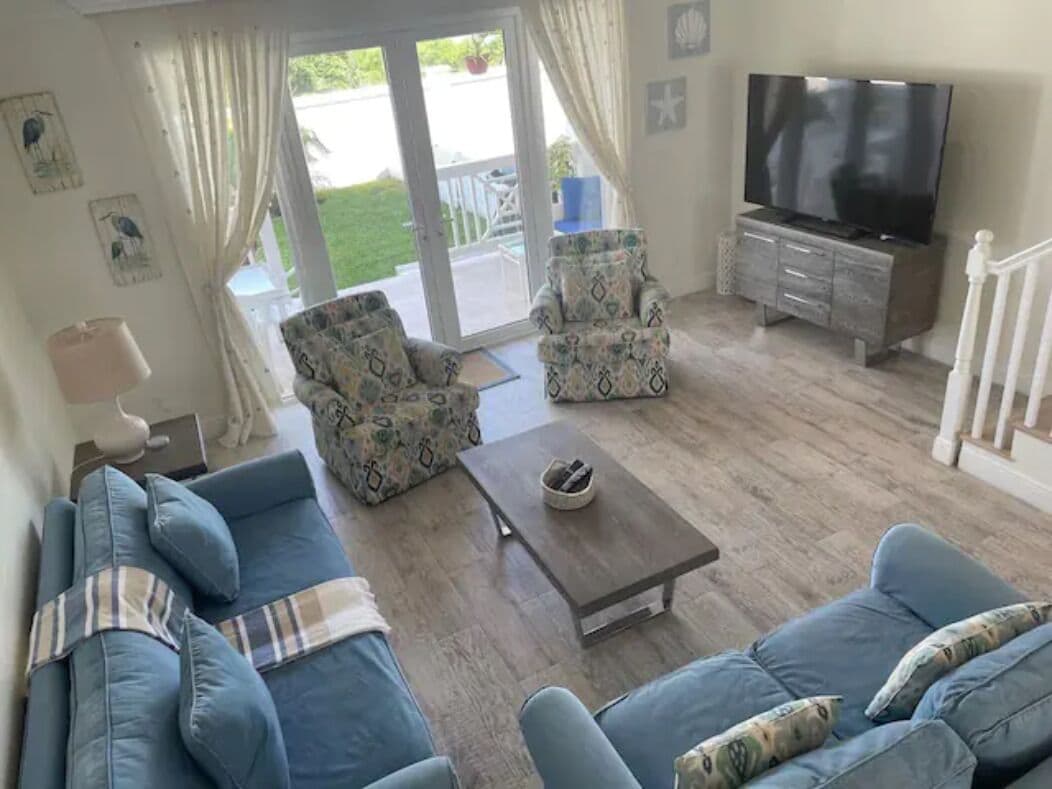 A living room with a sofa set, a coffee table, and a TV.