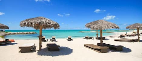 Private beach, white sand, sun loungers, beach umbrellas