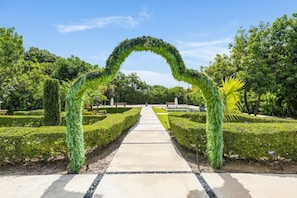 A pathway leading to a destination with a natural archway.