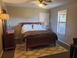Cozy retreat with a single bed, ceiling fan, and window for natural light.