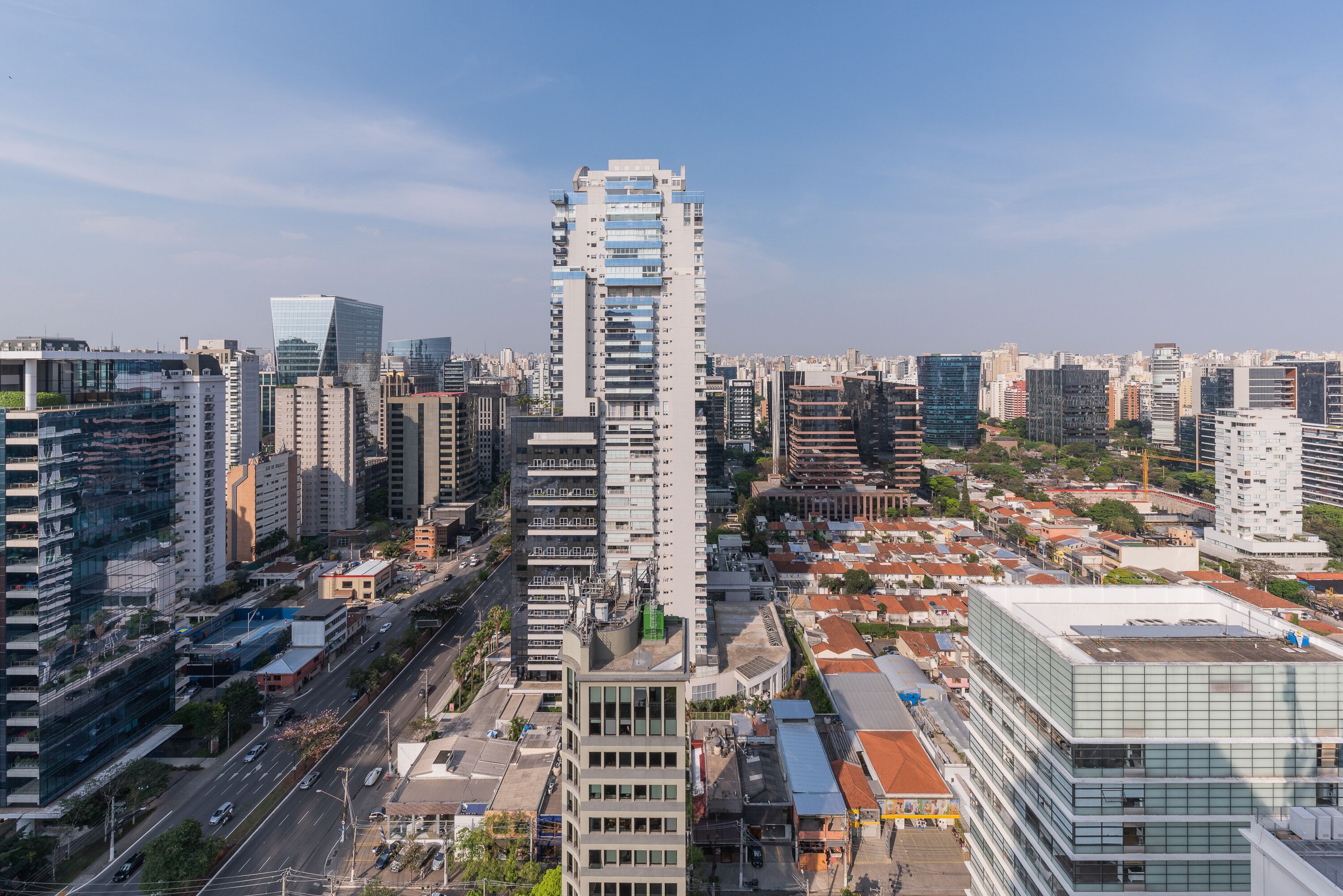 A high-rise building with multiple floors, surrounded by other tall buildings in a cityscape.